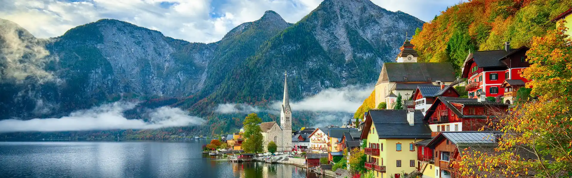 foggy-autumnal-sunrise-at-famous-hallstatt-lakeside-town-reflecting-in
