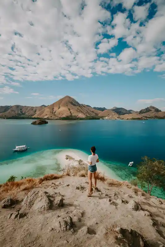 a-young-female-traveller-and-explorer-is-hiking-the-hill